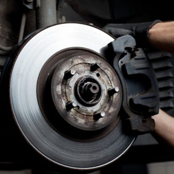 closeup of car mechanic repairing brake pads