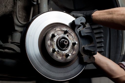 closeup of car mechanic repairing brake pads